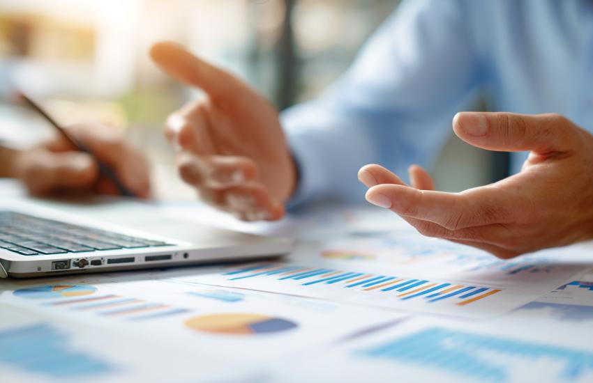 data, chart on the table with a person with open palms