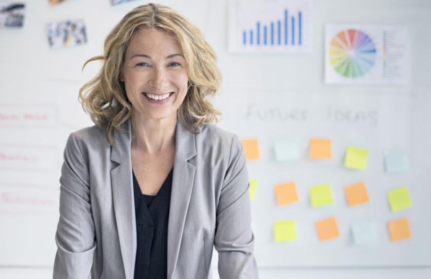 A lady with sticky notes in the background