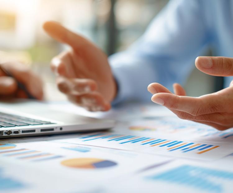 data, chart on the table with a person with open palms