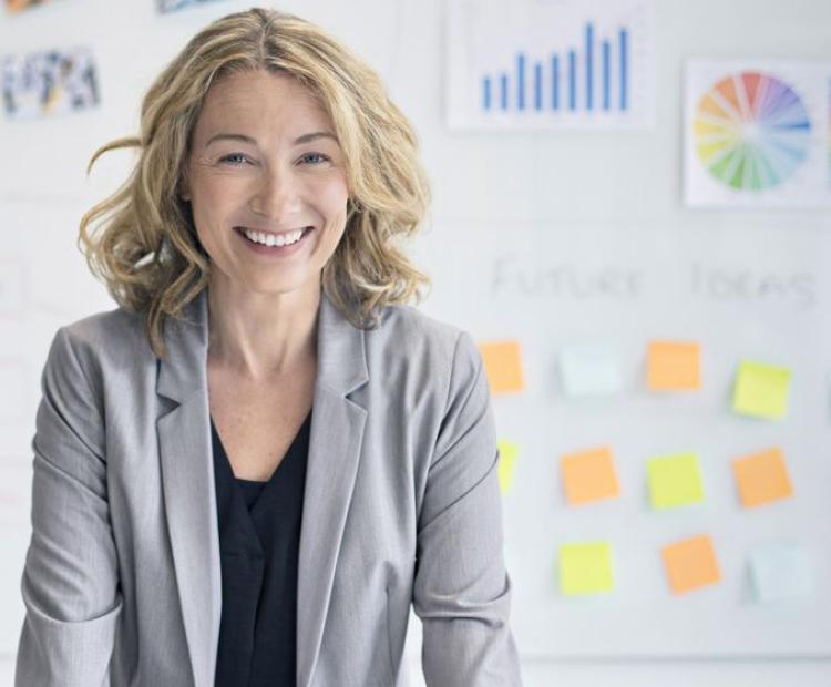 A lady with sticky notes in the background